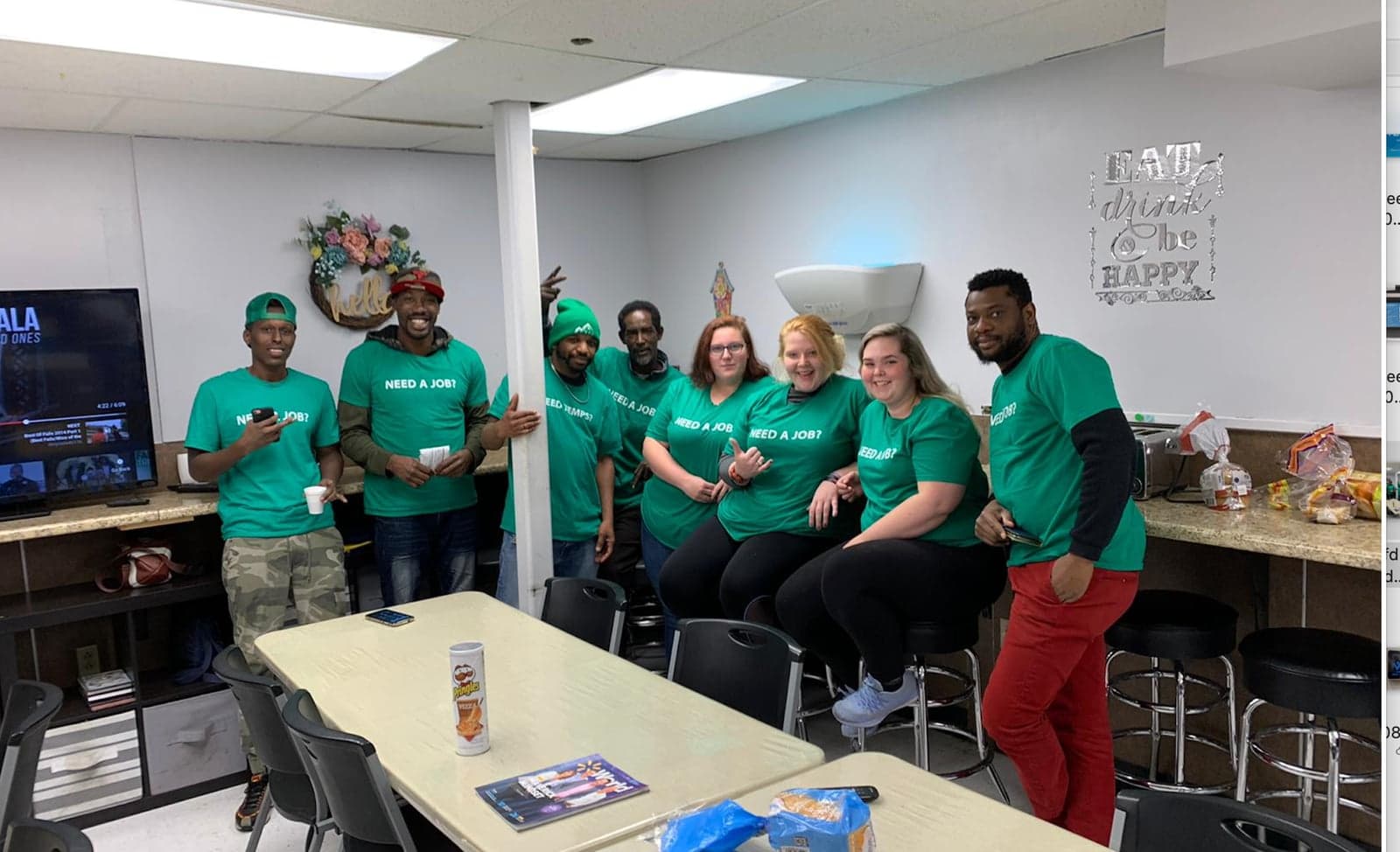 The VEA team gathered at the South Burlington office in green NEED A JOB shirts